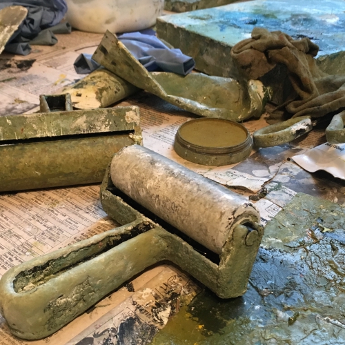green paint rollers in artist's studio