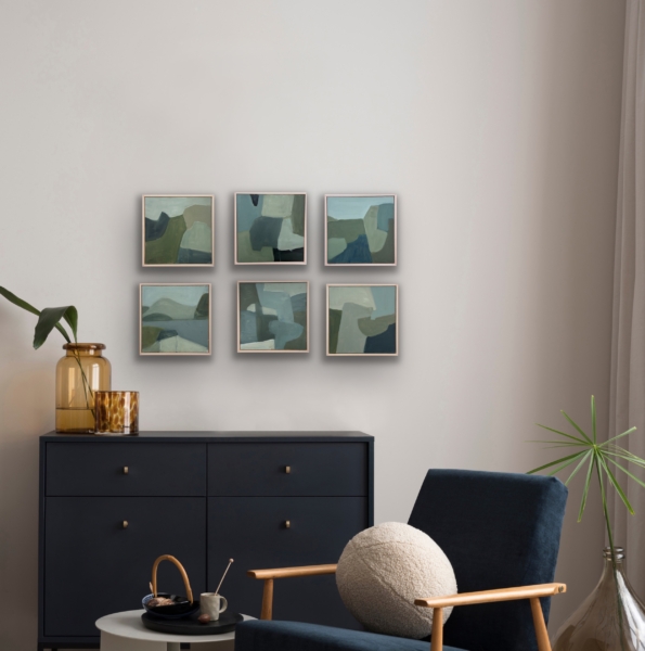 multiple 12" x12" piantings hung above a chest of drawers